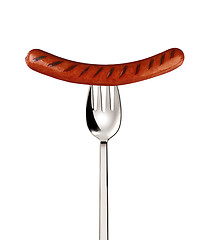 Image showing Close-up of fried sausage on a fork