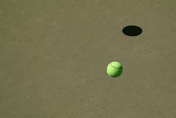 Image showing lonely Tennis Ball on a Sand Court