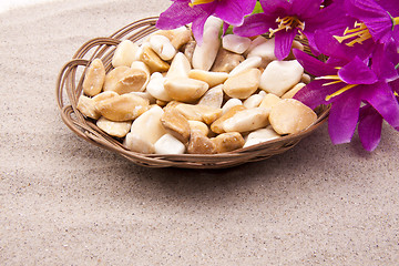 Image showing stones with flowers on beach