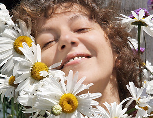 Image showing Smiling woman with daisies