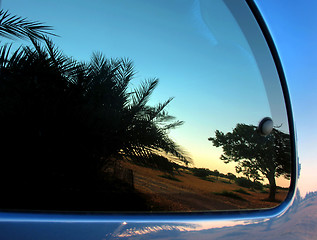 Image showing Sunset reflection in a car back window