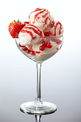 Image showing Ice cream with fresh berries and strawberry sauce