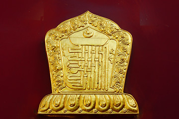 Image showing Golden decoration on a lamasery's red wall