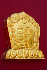 Image showing Golden decoration on a lamasery's red wall