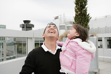 Image showing Father and daughter happy looking up outdoors
