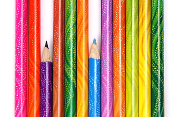 Image showing Assortment of coloured pencils with shadow on white background