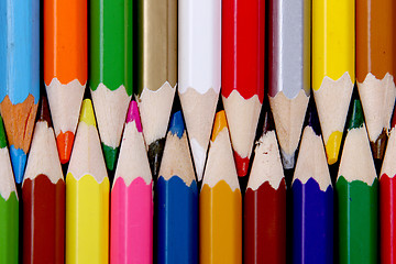 Image showing Assortment of coloured pencils with shadow on white/back backgro