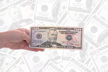 Image showing hand holding a dollar bill, business studio photo