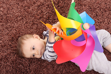 Image showing beautiful and happy baby with wind mill