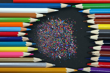 Image showing Assortment of coloured pencils with shadow on white/back backgro