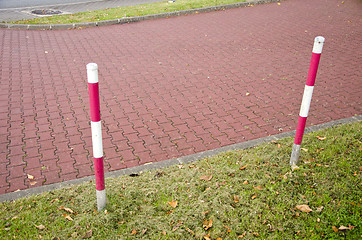 Image showing tiled park lane and protective barrier stakes 