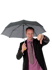 Image showing Businessman under umbrella giving a thumbs down