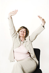 Image showing business woman stretching on chair