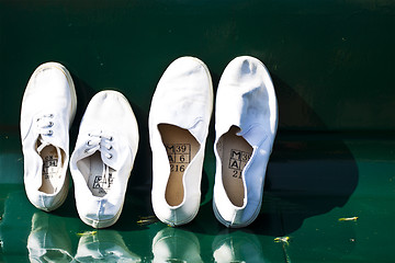 Image showing A pair of white shoes on chair