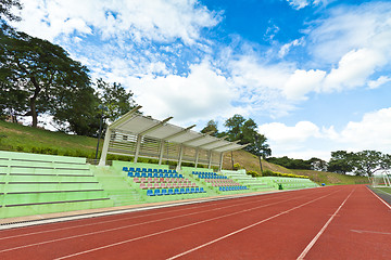 Image showing Stadium chairs and running track in a sports ground