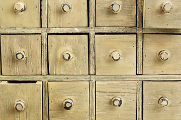 Image showing primitive apothecary drawer cabinet