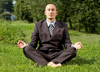 Image showing Businessman Meditating Outdoors 