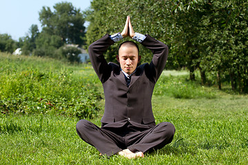 Image showing Businessman Meditating Outdoors 