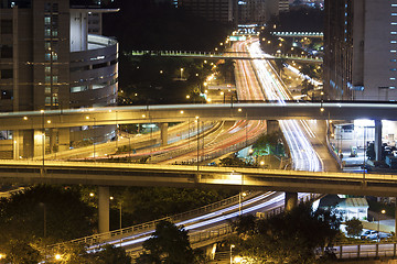 Image showing Modern city with night traffic downtown