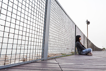 Image showing Asian sad woman on floor