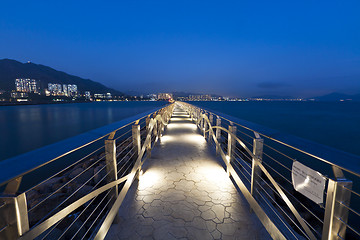 Image showing Walkway bridge along the coast at night