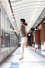 Image showing Running of a woman in rush hours on train station