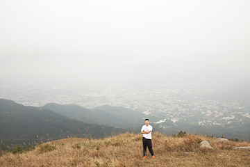Image showing Asian man hiking in mountains