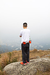 Image showing Asian man hiking in mountains