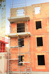 Image showing residential building under construction in red brick