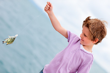 Image showing Boy holding caught fish