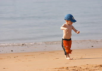 Image showing Small boy playing at sandy beach