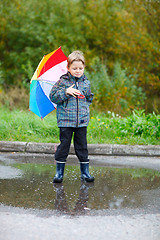 Image showing Cute boy outdoors at rainy day