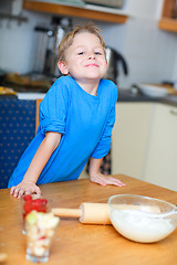 Image showing Boy helping at kitchen