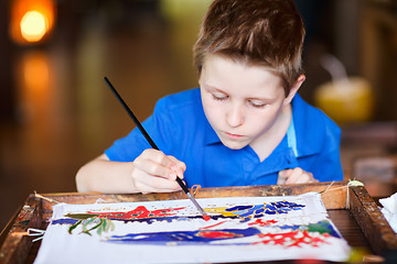 Image showing Boy painting a batik