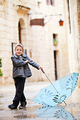 Image showing Cute boy on rainy day