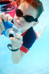 Image showing Little boy swimming underwater