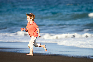 Image showing Kid runs on the beach