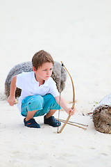 Image showing Cute boy playing with bow and arrows