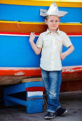 Image showing Boy near colorful boat