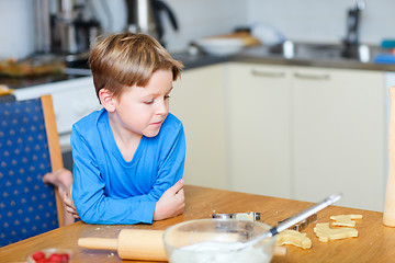 Image showing Boy helping at kitchen