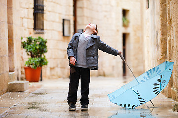 Image showing Cute boy on rainy day