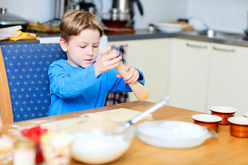 Image showing Boy helping at kitchen