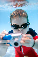 Image showing Little boy swimming underwater