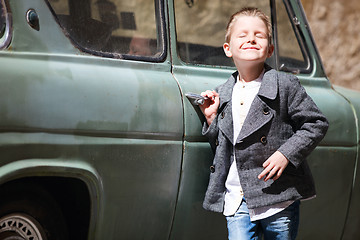 Image showing Boy near car