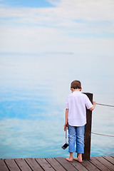 Image showing Little boy looking at ocean