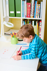 Image showing Little boy studying at home