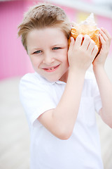 Image showing Cute boy with seashell