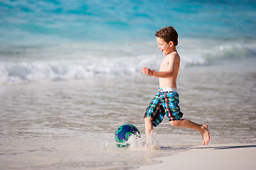 Image showing Boy playing with ball on beach