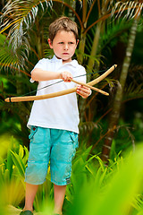 Image showing Cute boy playing with bow and arrows