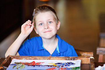 Image showing Boy painting a batik